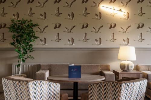 a waiting room with a table and chairs at Craig Manor in Bowness-on-Windermere