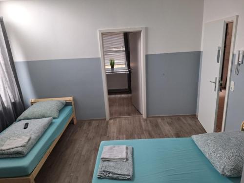 a small room with two beds and a window at Kapitän-Dallmann-Str in Bremen