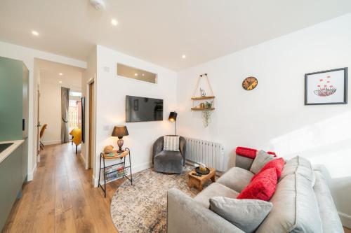a living room with a couch and a tv at Grange8 Luxury Snug & Courtyard in Blairgowrie in Blairgowrie