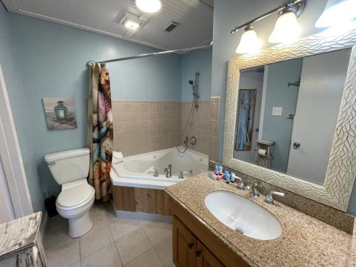 een badkamer met een wastafel, een toilet en een bad bij Paradise PRN in Gulf Shores