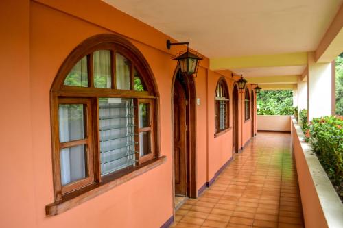 an empty hallway of a house with windows at El Tucano Resort & Thermal Spa in Quesada