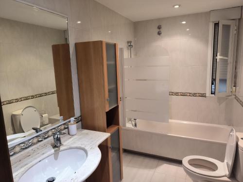 a bathroom with a sink and a toilet and a tub at Casa Nano in Sigüeiro