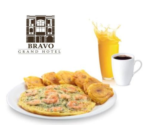 un plato de huevos y pan con una taza de café en HOTEL BRAVO GRAND HOTEL, en Quevedo