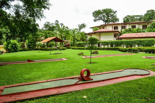 a statue of a ribbon on a grass field at El Tucano Resort & Thermal Spa in Quesada