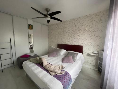 a bedroom with a dog laying on a bed at Chez Cathy in LʼHoumeau