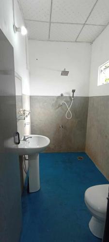 a bathroom with a white sink and a toilet at Quiet Place villa with kitchen in Tangalle