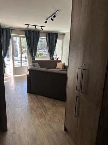a living room with a couch and a large window at Aja apartman Family lux Divčibare in Divčibare