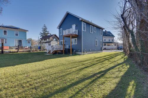 a blue house on a yard with a large grass field at Renovated Family Home on Providence River! in Riverside