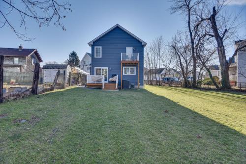 a blue house on a yard with a grass field at Renovated Family Home on Providence River! in Riverside
