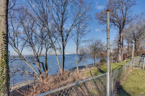 a fence next to a body of water at Renovated Family Home on Providence River! in Riverside