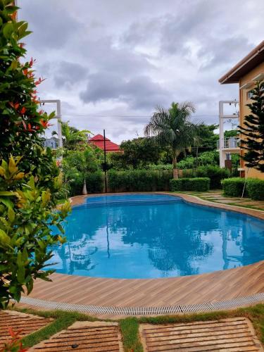 a swimming pool in the yard of a house at VERDANT by Vista Manors Deluxe Rooms with Balcony, Gym and Swimming Pool in Puerto Princesa City