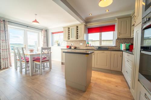 a kitchen with a table and chairs and a kitchen with a counter at no9 Ard Na Mara in Dingle