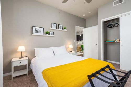 a bedroom with a large bed with a yellow blanket at Chic King Bed Desk w/ Pool in San Antonio