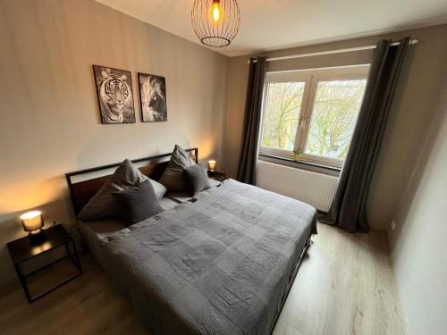 a bedroom with a large bed and a window at Apartment Central 10H 75qm Wi-Fi free Parking in Dortmund