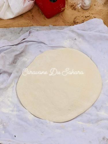a piece of dough sitting on top of a table at Private Camp25km-from DOUZ in Douz