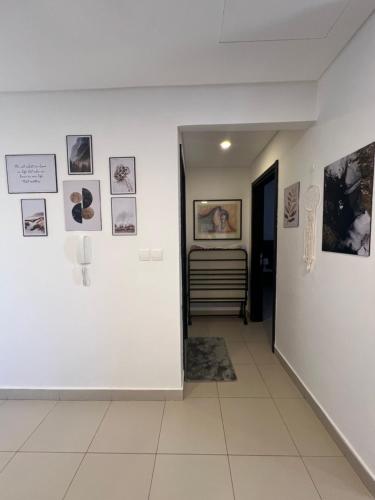 a hallway with pictures on the walls of a room at Spacious apartments with Sea view at Samarah Resort in Sowayma