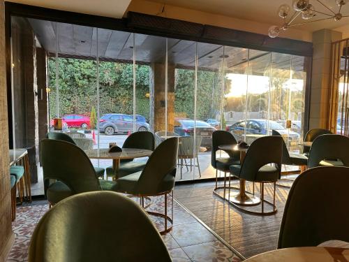 a restaurant with tables and chairs and a view of a parking lot at Cozy apartment New Cairo in New cairo