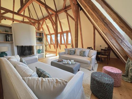 a living room with white furniture in a room with wooden beams at TURM KAPS Luxury home direkt am Golfplatz by Belle Stay in Kitzbühel