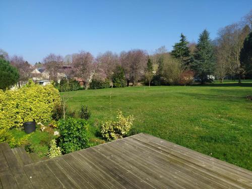 a view of a yard with a field of grass at Le gite du lavoir in Suzy