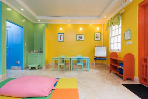a colorful room with a table and chairs at The Crane Resort in Saint Philip