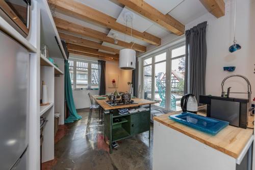 a kitchen with wooden ceilings and a large window at Arthostel Martine in Unkel