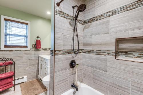 a bathroom with a shower and a bath tub at Shirley Vacation Rental with Hot Tub, 7 Mi to Beach! in Shirley