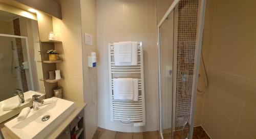 アロマンシュ・レ・バンにあるLa Maison Du 6のバスルーム(シャワー、シンク、鏡付)