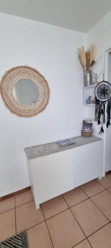 a room with a counter and a mirror on the wall at Appartement face à la mer dans le charmant village de Sausset-les-pins in Sausset-les-Pins