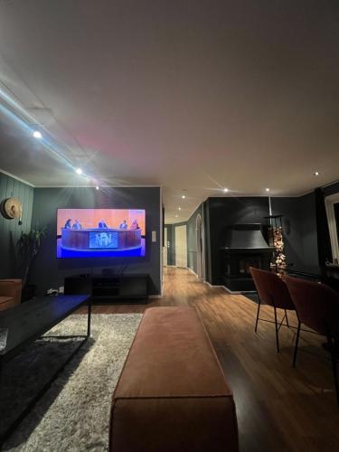 a living room with a large flat screen tv at All inclusive villa with everything you need in Lillehammer