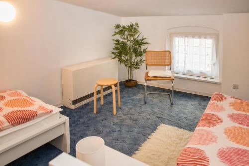 a bedroom with a bed and a table and a chair at 3 Zimmer - Ferien & Monteur Maisonette in Magdeburg, H in Magdeburg
