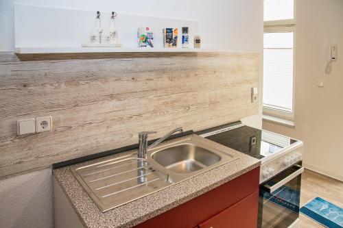 a kitchen with a stainless steel sink in a counter at 3 Zimmer - Ferien & Monteur Maisonette in Magdeburg, H in Magdeburg
