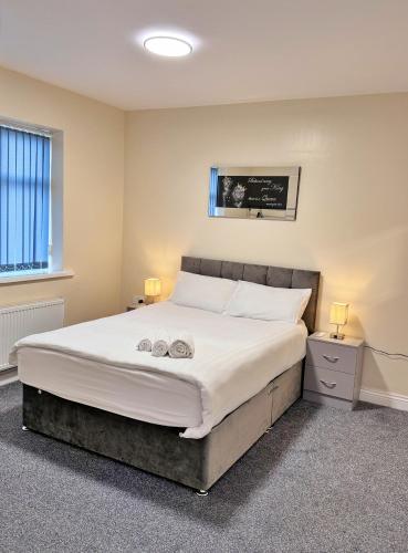 a bedroom with a bed with two towels on it at Full Home in Heywood Street near Cheetham Hill in Manchester