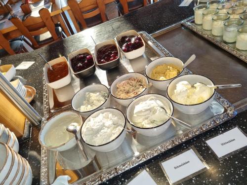 a buffet with bowls of food on a table at Gästehaus St. Martin in Ulmen