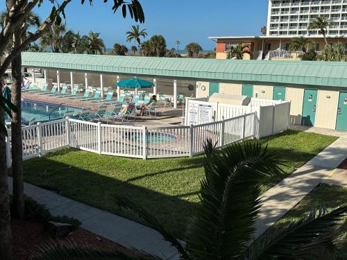 a white fence in front of a swimming pool at Treasure Island Beach Club 727-360-7096 in St Pete Beach