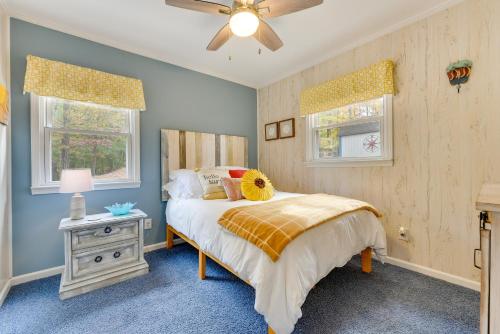 a bedroom with a bed and a ceiling fan at Cheerful Lake Wylie Home with Fire Pit! in Charlotte