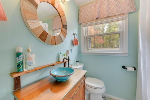 a bathroom with a bowl sink and a mirror at Cheerful Lake Wylie Home with Fire Pit! in Charlotte
