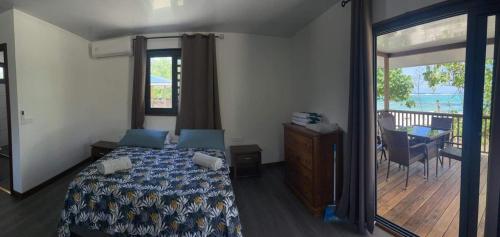 Parea的住宿－Parea Lodge Huahine Bungalow 1#MAHANA，一间卧室配有一张床,享有甲板的景色