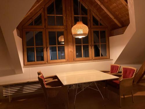 a dining room with a table and chairs and a chandelier at Villa Riedhart in Kramsach
