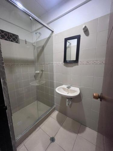 La salle de bains est pourvue d'un lavabo et d'une douche. dans l'établissement Hotel Viva Villavicencio, à Villavicencio
