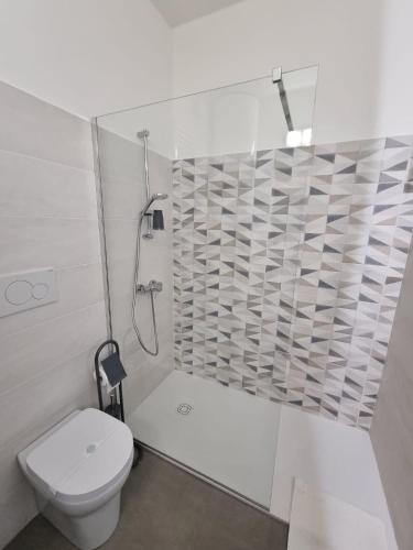 a white bathroom with a toilet and a shower at Casa Panigale Bologna in Bologna