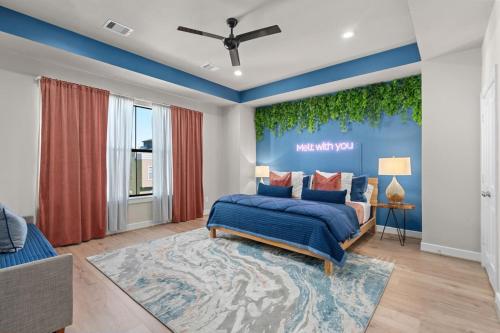 a bedroom with a bed and a blue wall at New - Home Sweet Houston in Houston