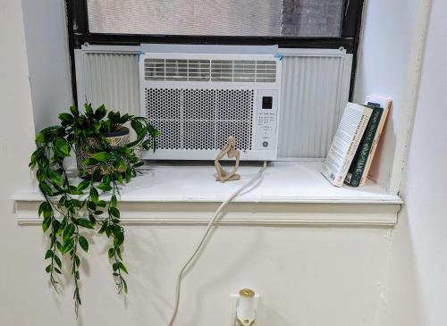 a window with a air conditioner on a window sill at Studio in Union Square in New York