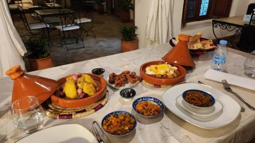 a table with many plates of food on it at Dar S'BAH in Fès