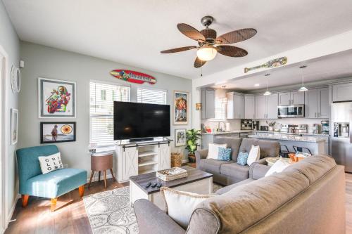 a living room with a couch and a flat screen tv at Hot Tub and Yard Jimmy Buffet-Themed Galveston Home in Galveston