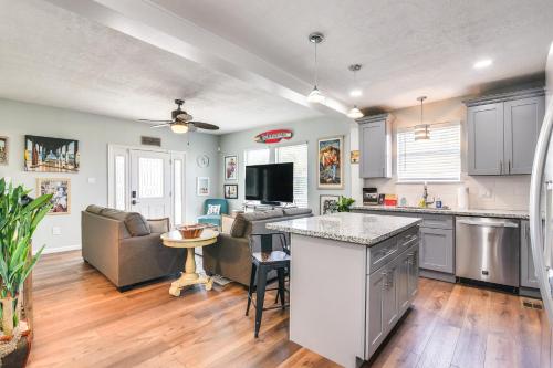 a kitchen and living room with a couch and a table at Hot Tub and Yard Jimmy Buffet-Themed Galveston Home in Galveston