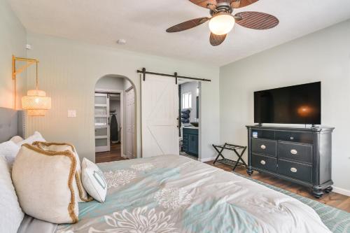 a bedroom with a bed and a flat screen tv at Hot Tub and Yard Jimmy Buffet-Themed Galveston Home in Galveston