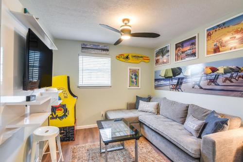 a living room with a couch and a guitar at Hot Tub and Yard Jimmy Buffet-Themed Galveston Home in Galveston