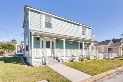 a white and blue house with a porch at Hot Tub and Yard Jimmy Buffet-Themed Galveston Home in Galveston