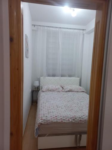 a small bedroom with a bed and a window at Lavander in Banja Luka