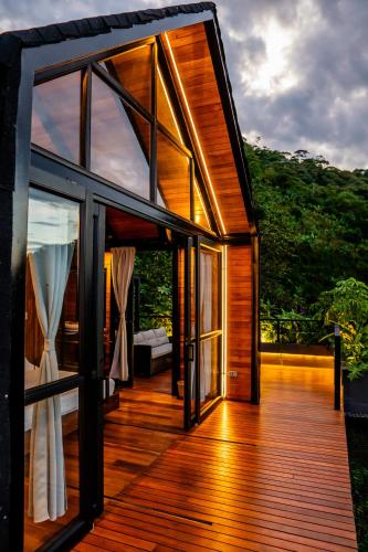 an open door to a house with windows at Selva Negra Cabins in Pereira